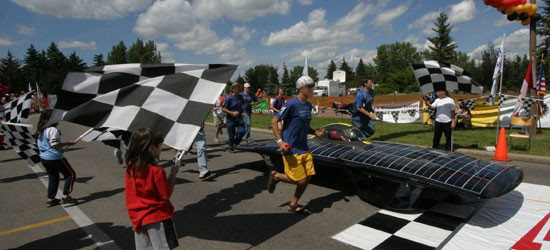 Playing with Fusion founders crossing the finish line with the ISU solar car, 'Fusion'
